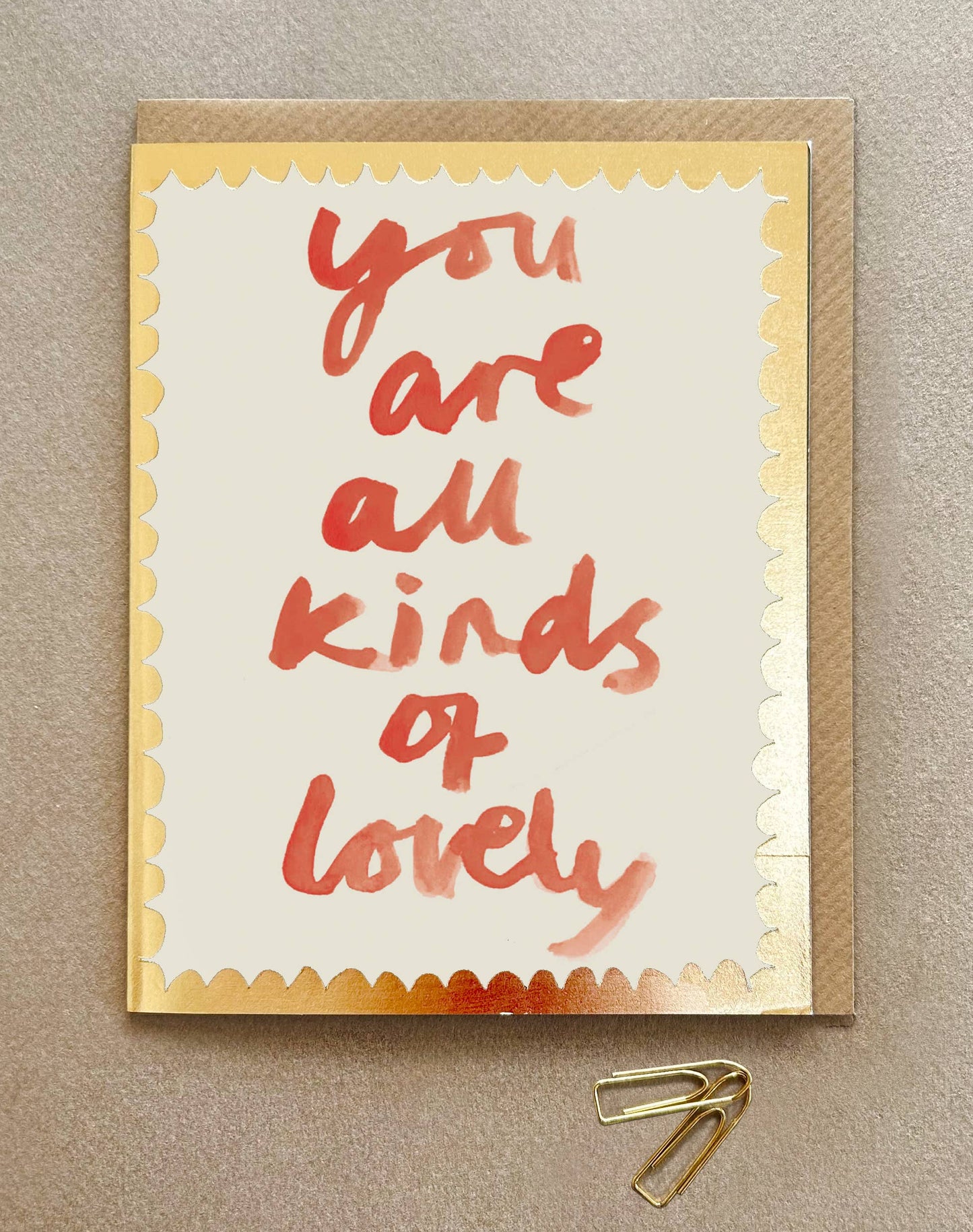 In red water colour paint You are all kinds of Lovely on a cream card with gold embossed edging.