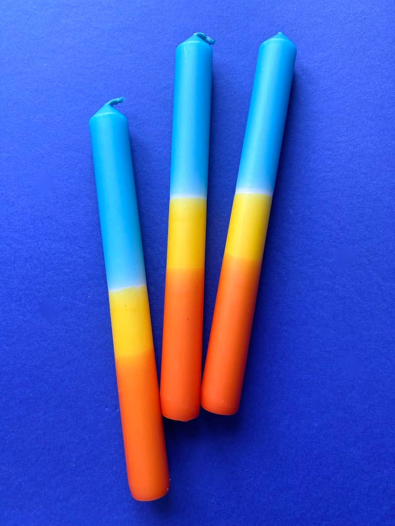 Trio of dip dyed candles. A band of orange, yellow and topped with turquoise.