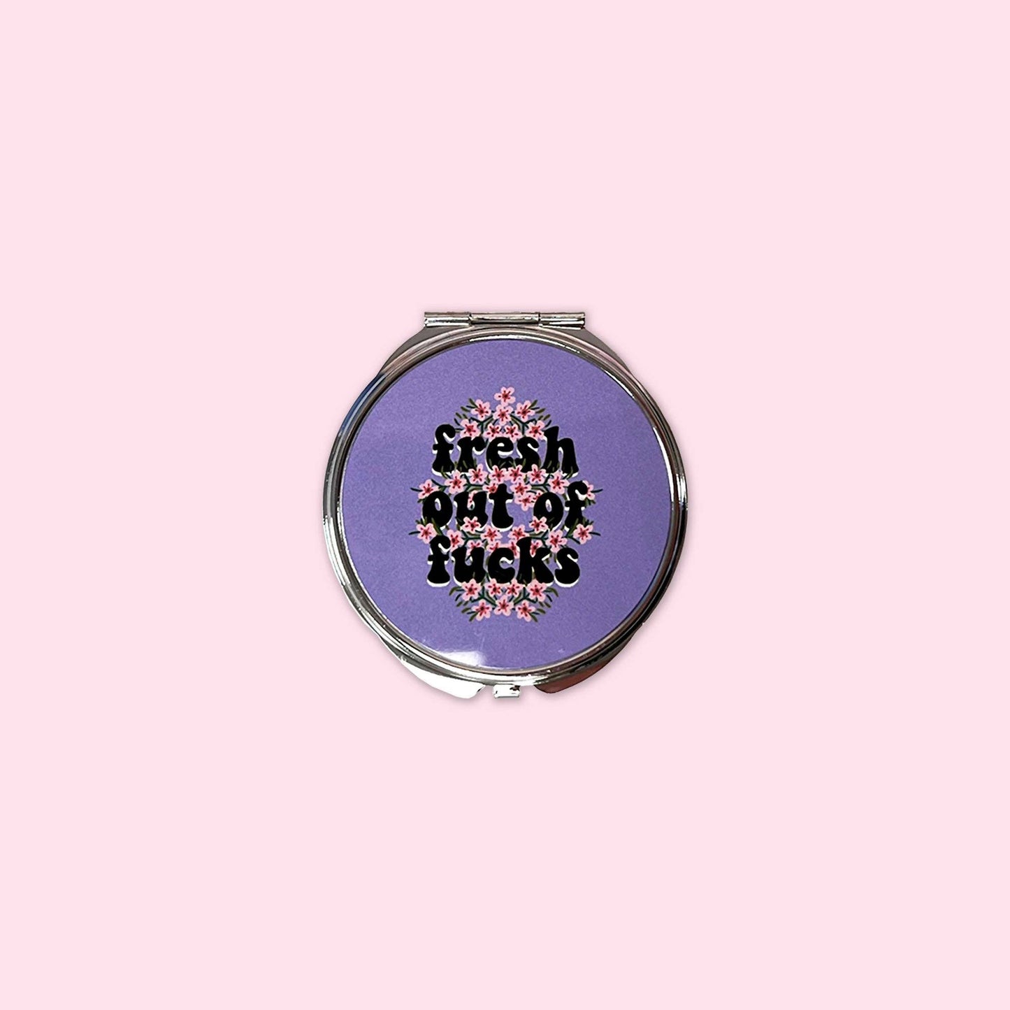 Small mirror compact with the words Fresh out of Fucks.