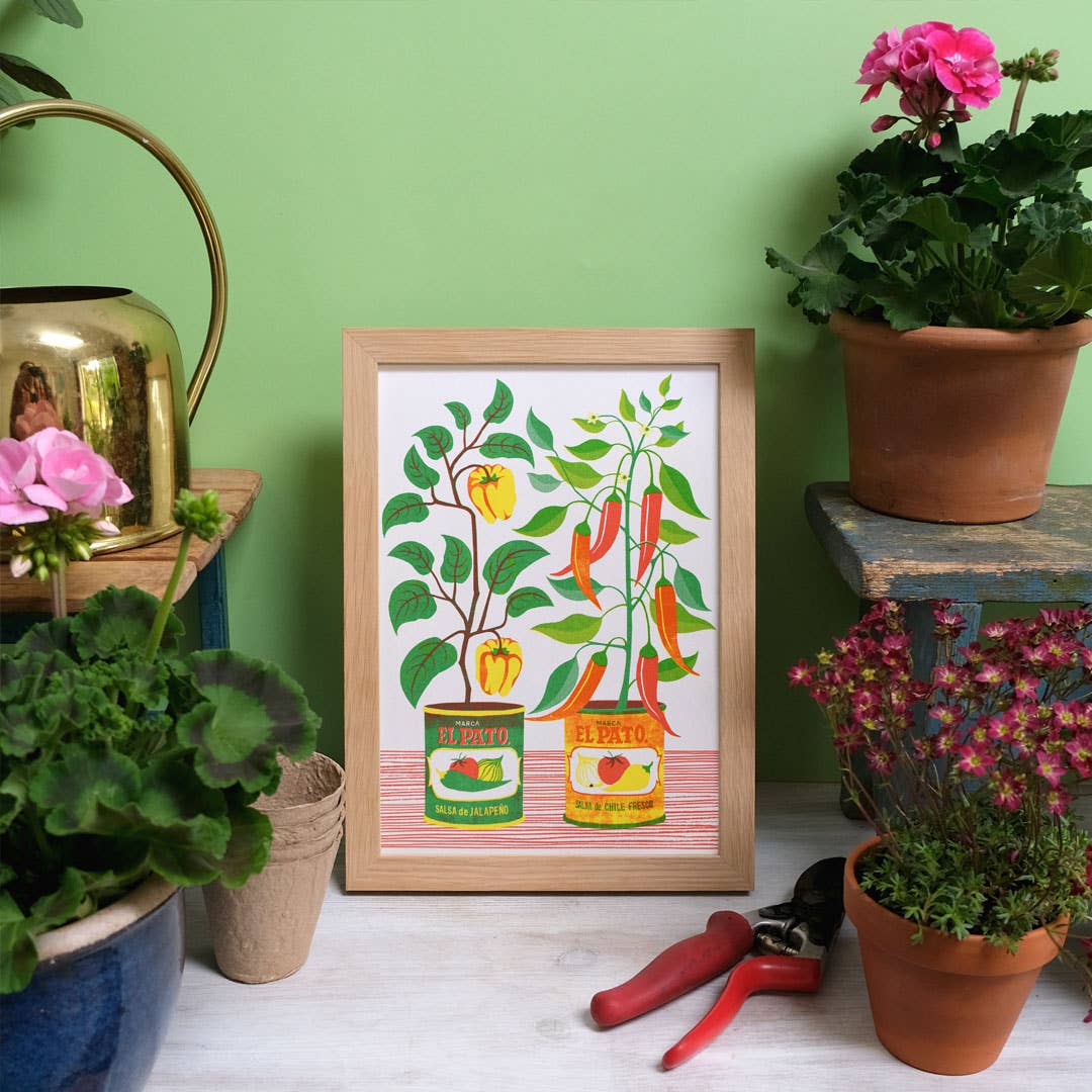Risograph print of chillis growing in tins.