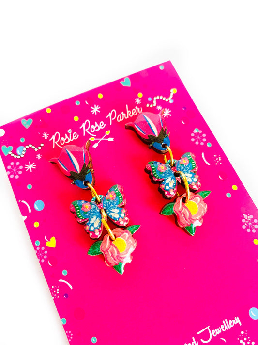 Bright floral and butterfly drop wooden and resin earrings.