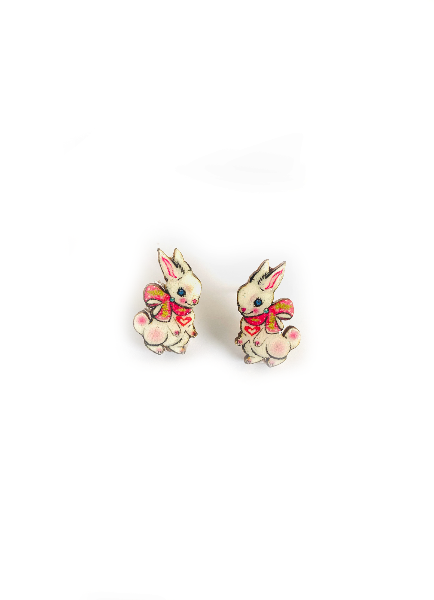 Little white bunnies with ribbon studs, made from wood and resin.