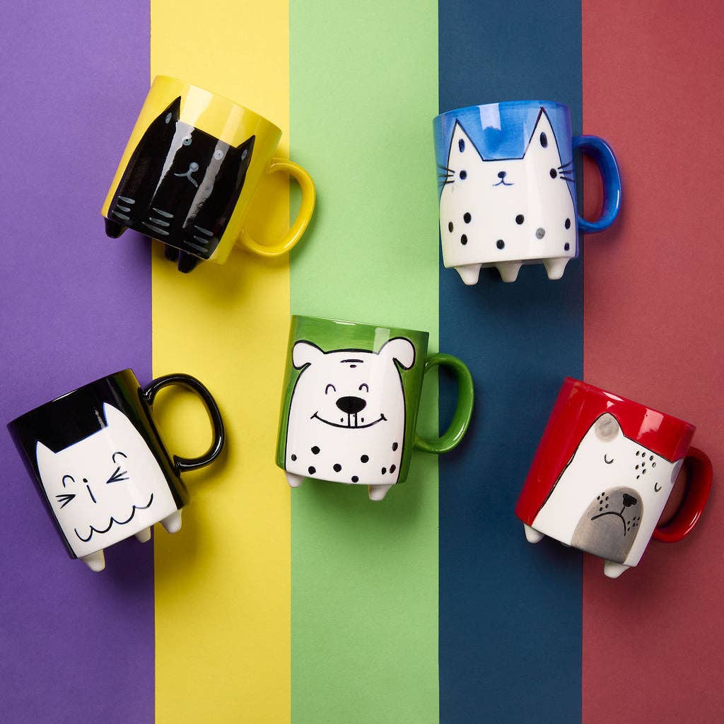 Colorful mugs with animal designs on a multicolored background