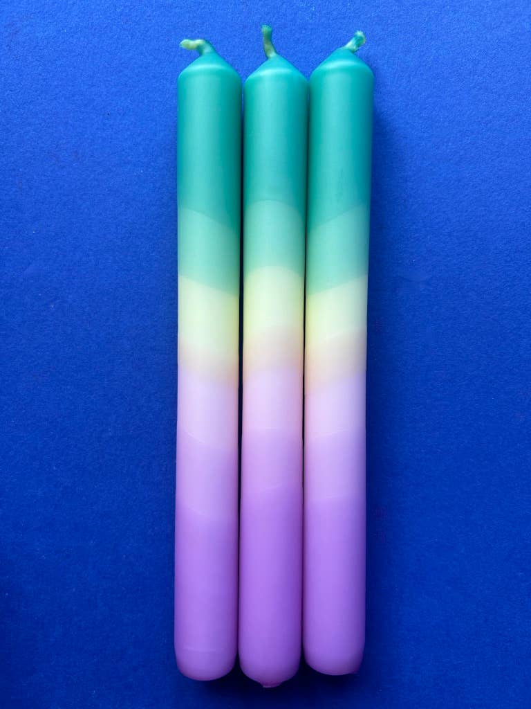 Set of 3 table candles. Colours pastel lilac moving through yellow topped with teal.