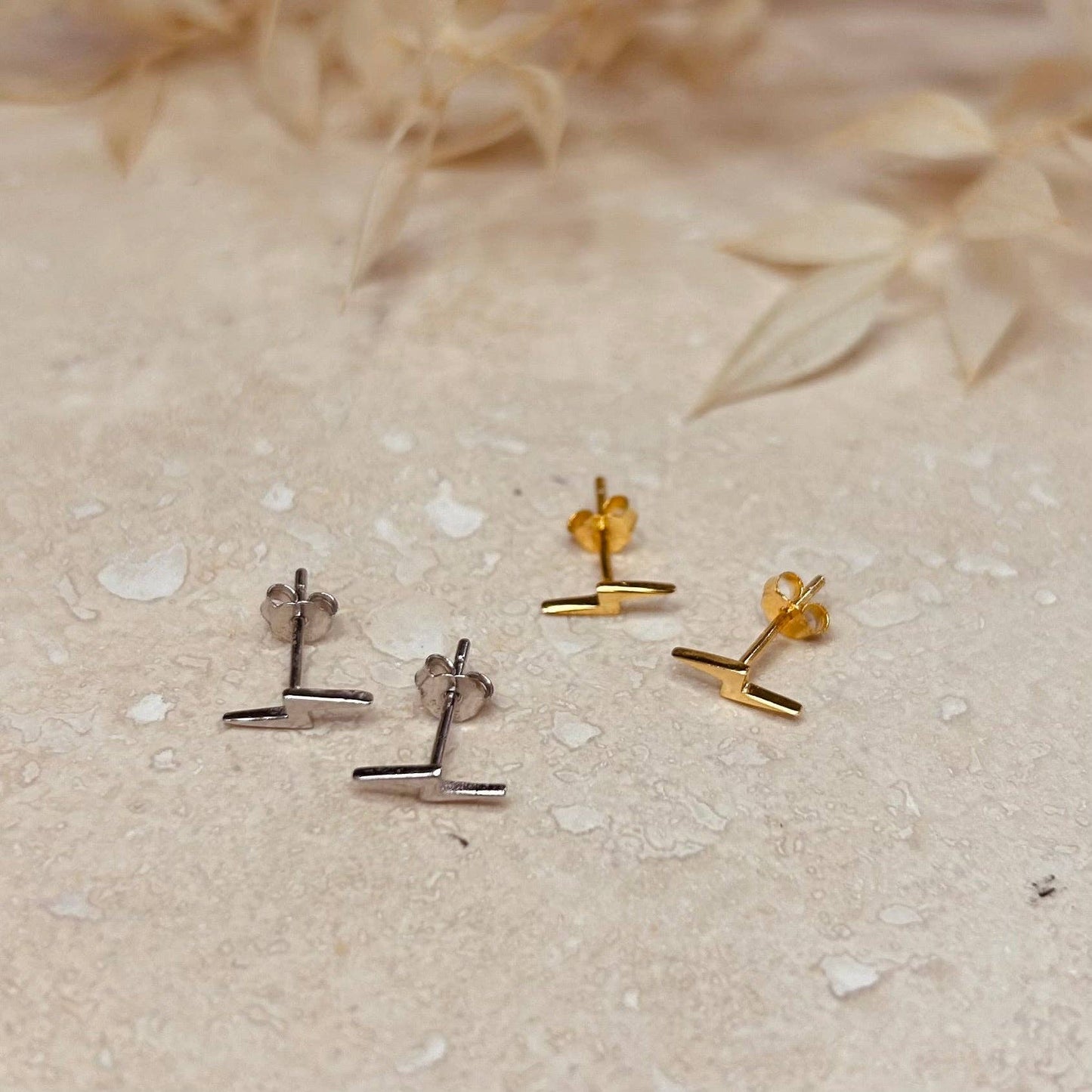 Mini lightening bolt studs in gold or silver.