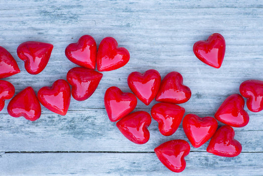 Red heart-shaped objects on a wooden surface