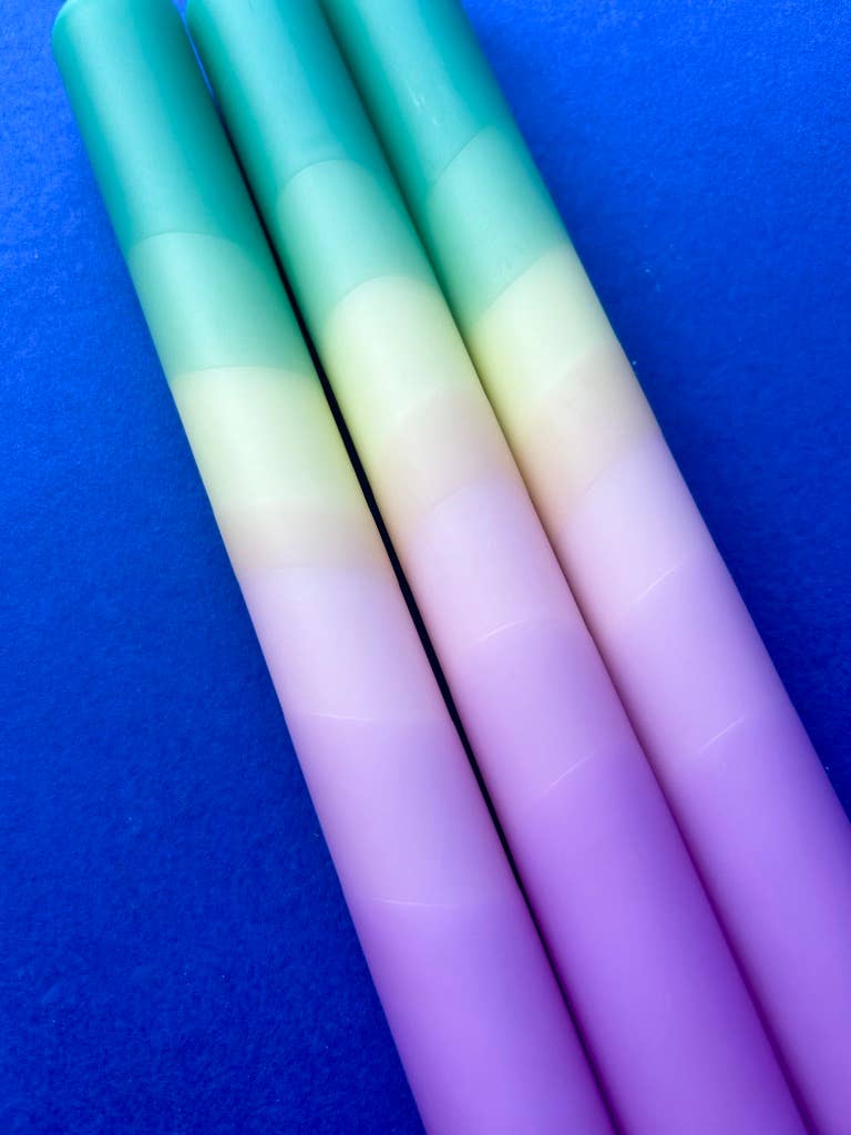 Set of 3 table candles. Colours pastel lilac moving through yellow topped with teal.
