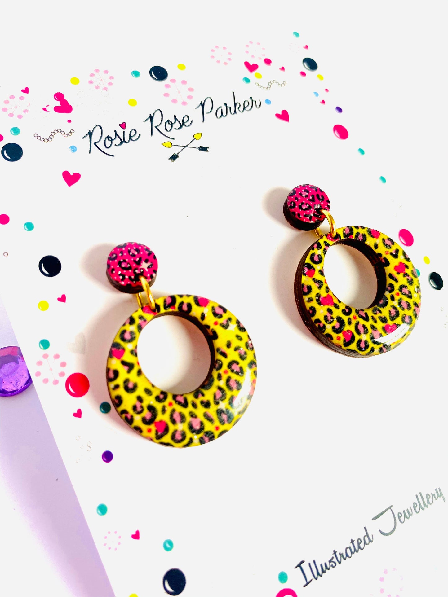Pink and yellow leopard print earrings made from resin and wood.