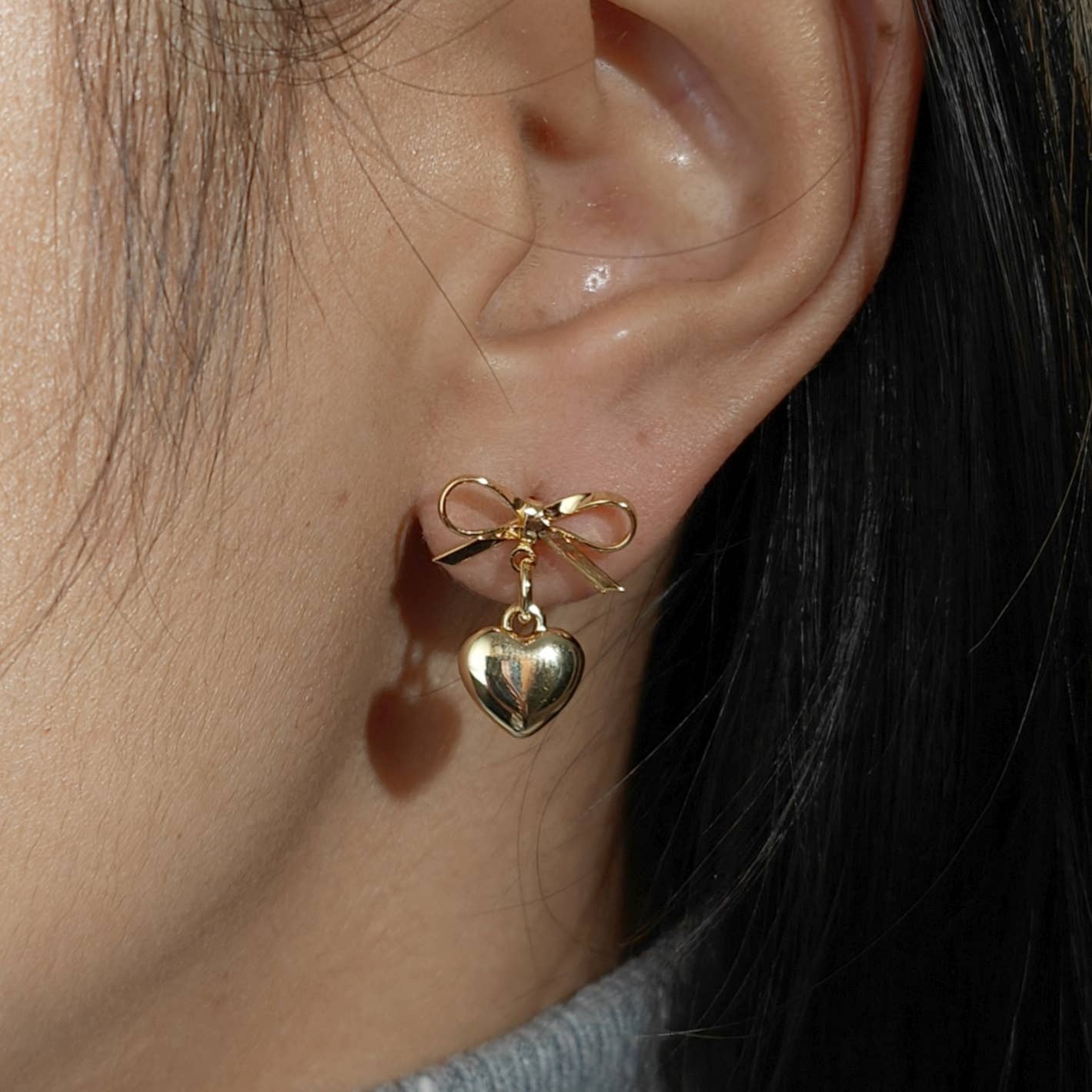 Gold plate bow with dangling heart