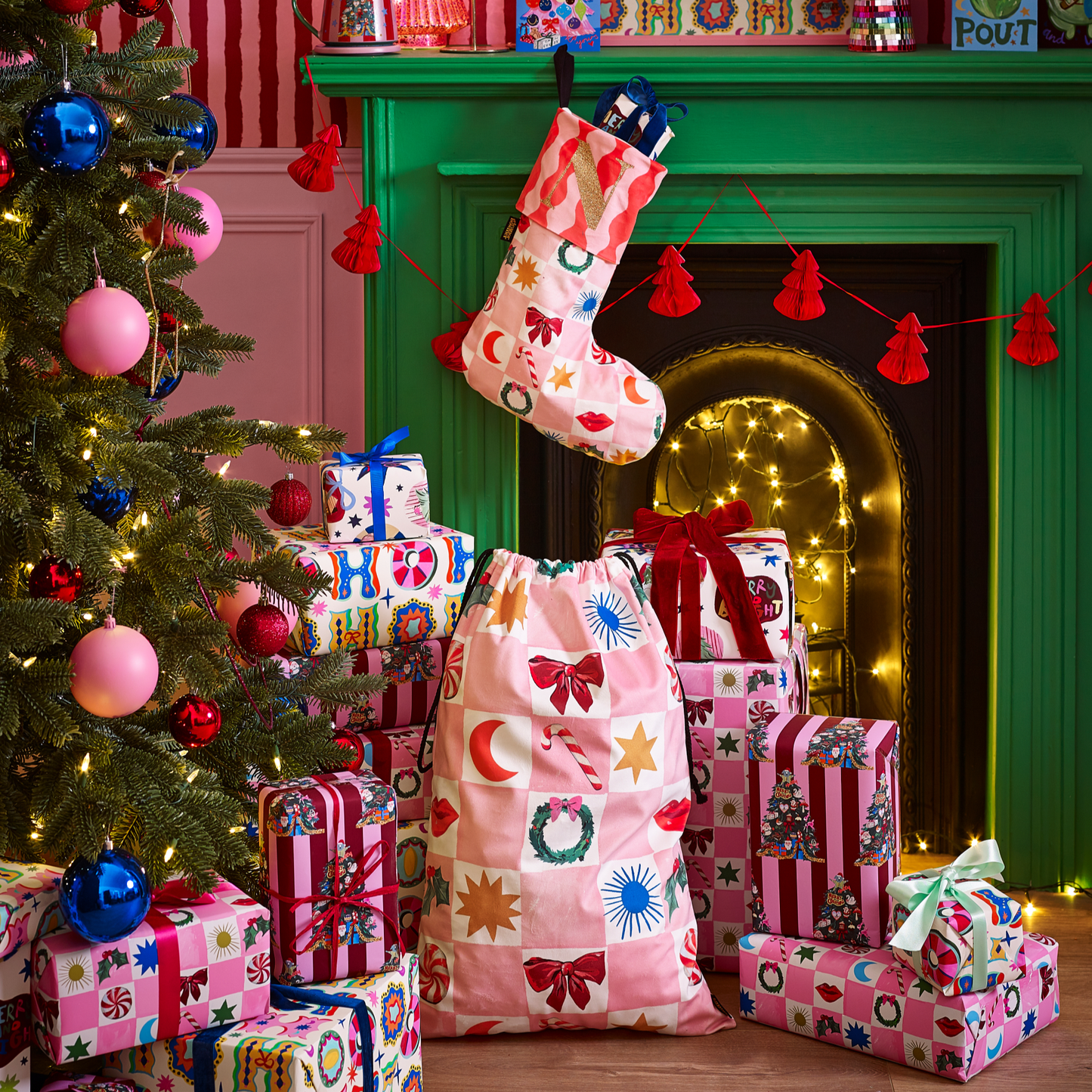 Colorful Christmas presents under a decorated tree with a green fireplace.