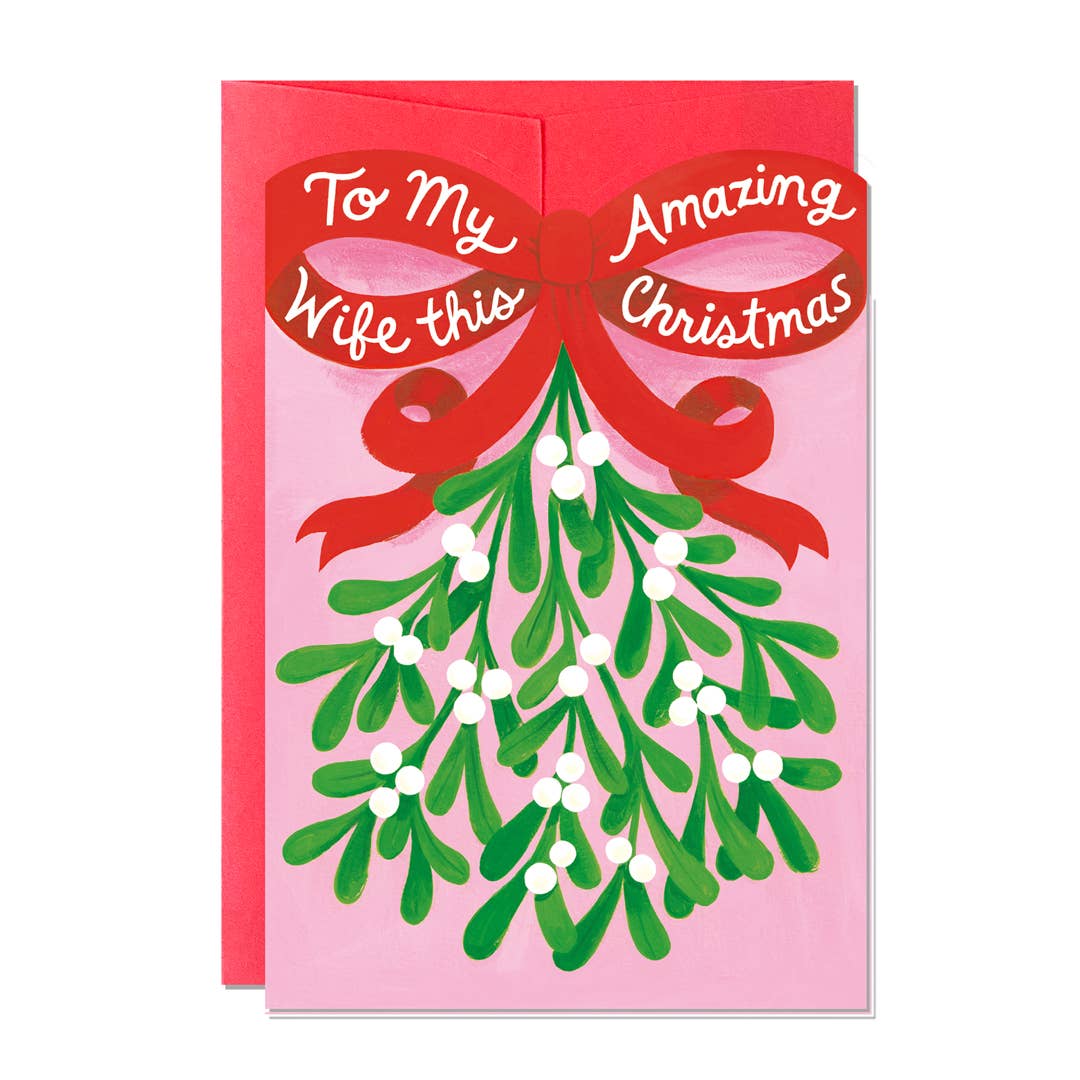 Christmas card. Text is To my amazing wife this Christmas. Illustrations of a bunch of mistletoe with a big red ribbon.