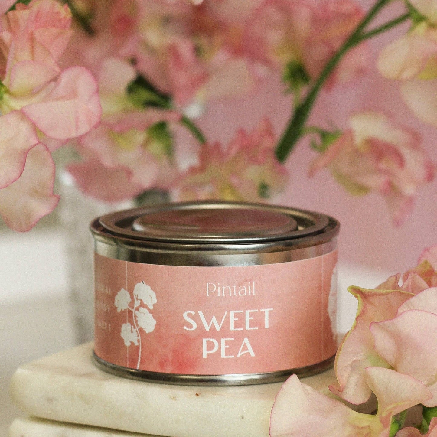 Sweetpea hand poured candle in a small tin with lid.