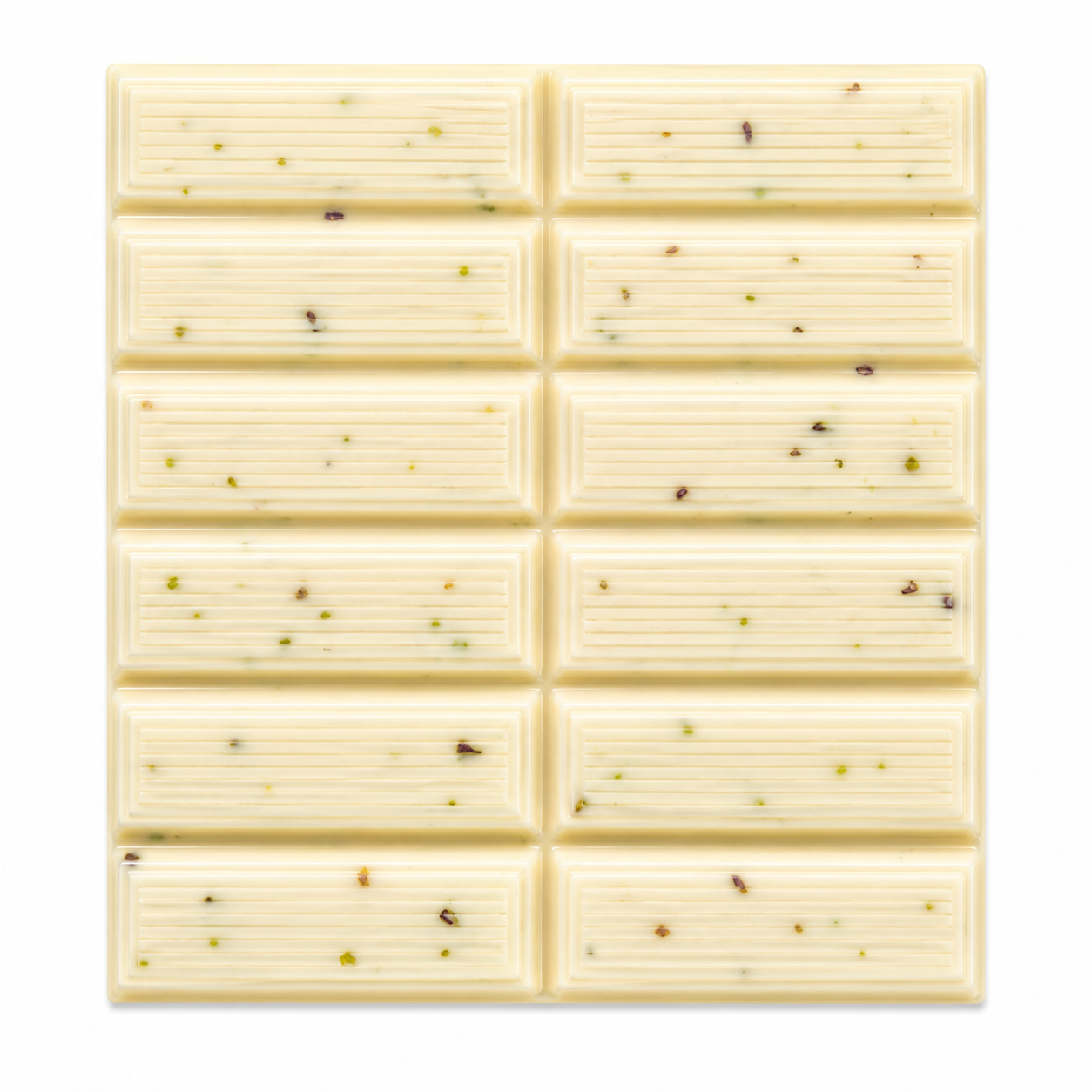 A square white chocolate bar with a grid of ten rectangular sections, each containing small scattered green and brown specks, shown on a plain white background.