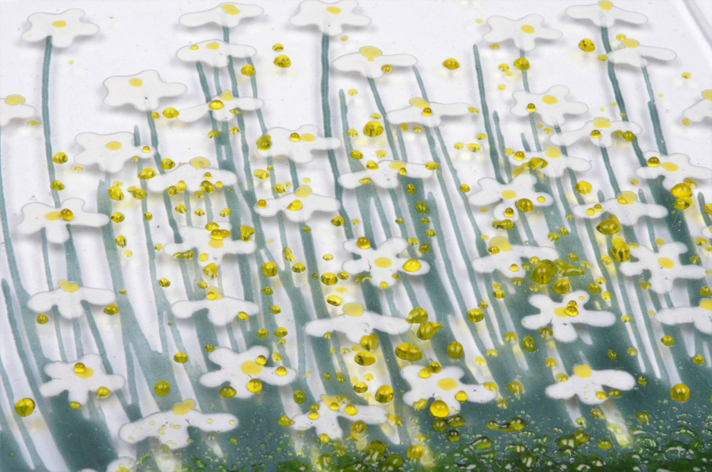Close-up of a textured surface with white floral patterns and yellow accents.