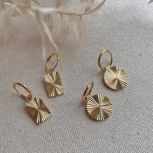 Round facetted gold plated earrings on hoops.