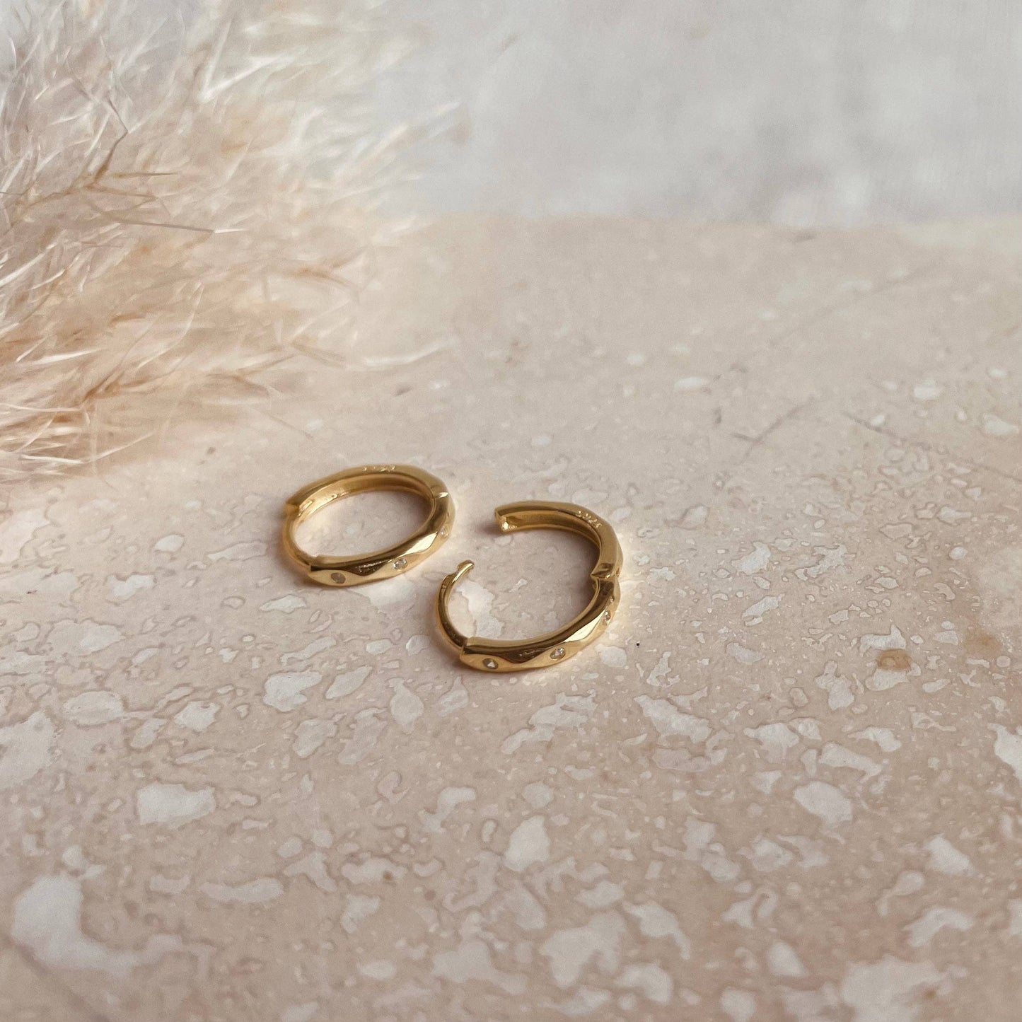 Gold plated huggy earrings with 3 tiny sparkle stones.
