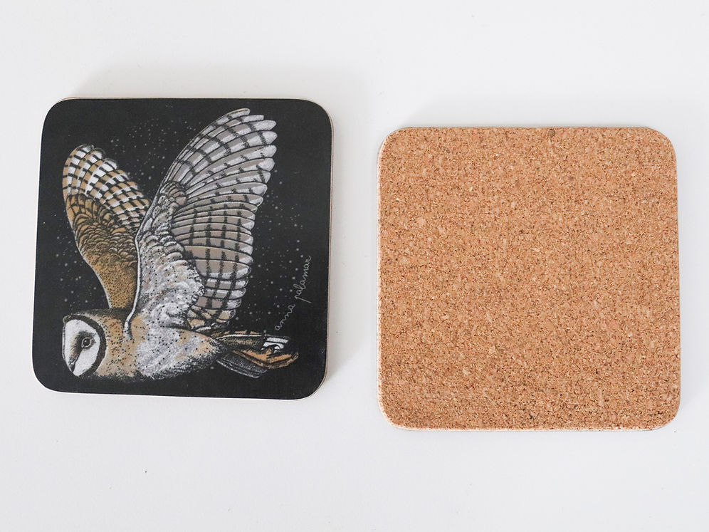Two square coasters on a white background: one black coaster with a detailed barn owl illustration in flight, and one plain natural cork coaster showing its textured back.