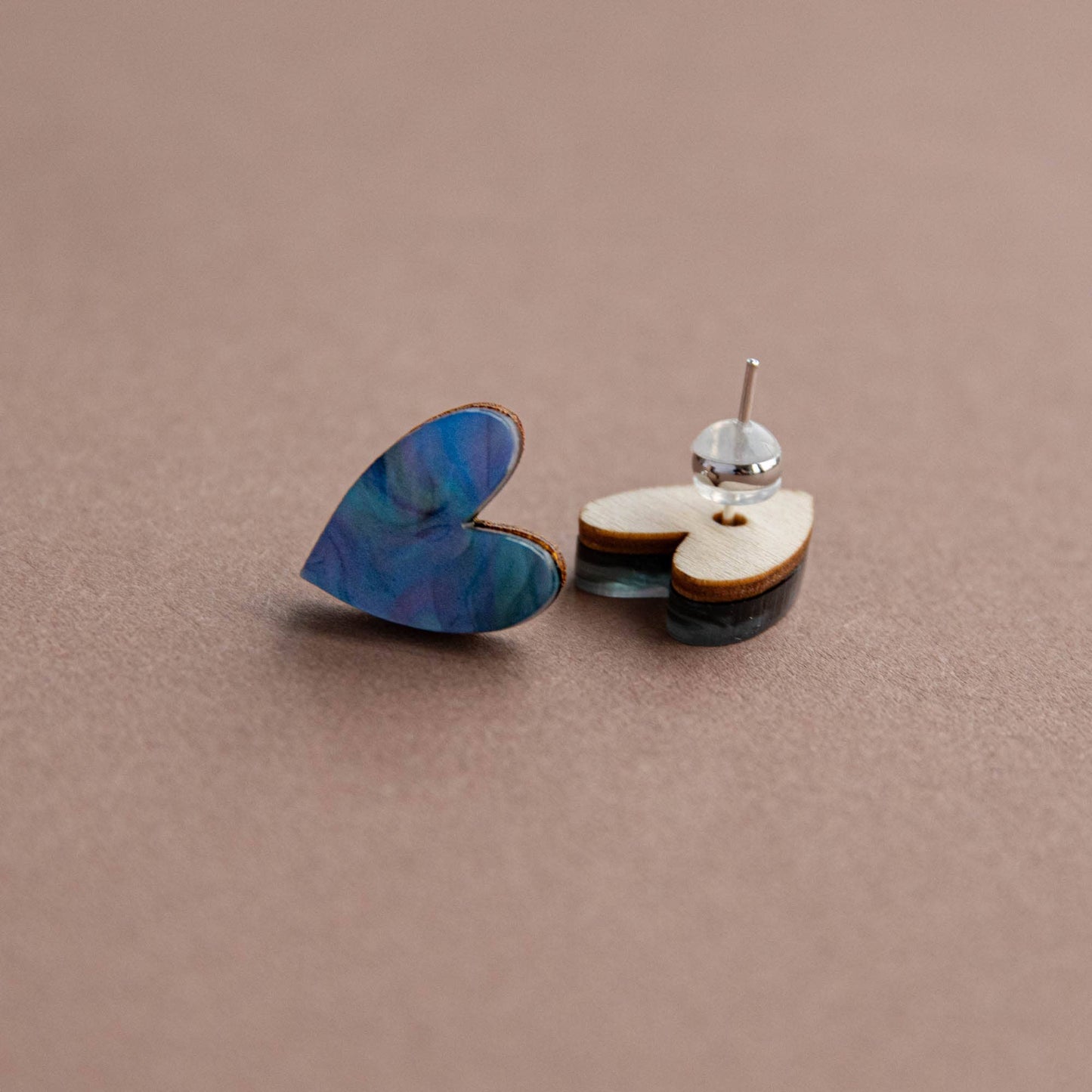 Heart-shaped earrings on a beige background