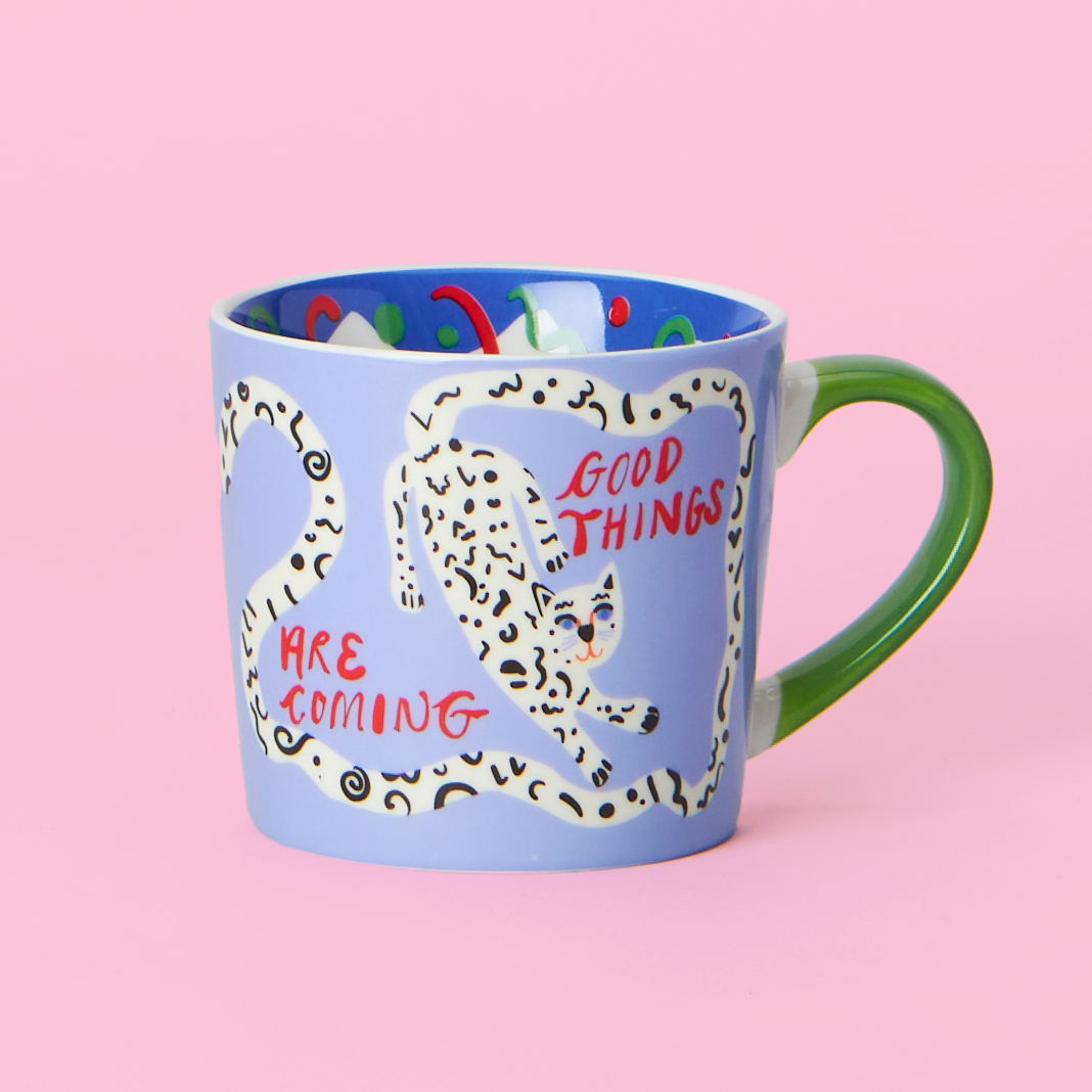 Mug with a leopard design and text 'Good Things Are Coming' on a pink background