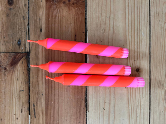 Neon pink and orange heater skelter table candle.