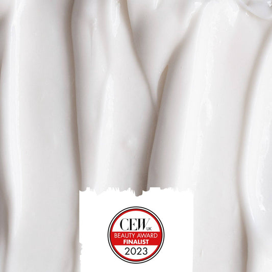Close-up of white cream with CEIL Beauty Award Finalist 2023 badge.