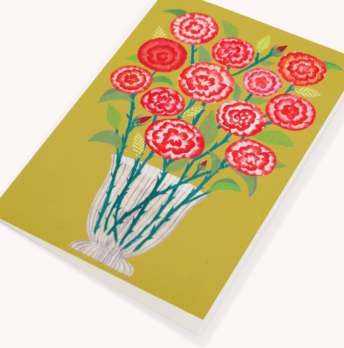 Notebook with red floral design on a green background