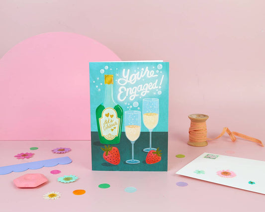 You're engaged card with bubbly and strawberries. Card is blank inside.