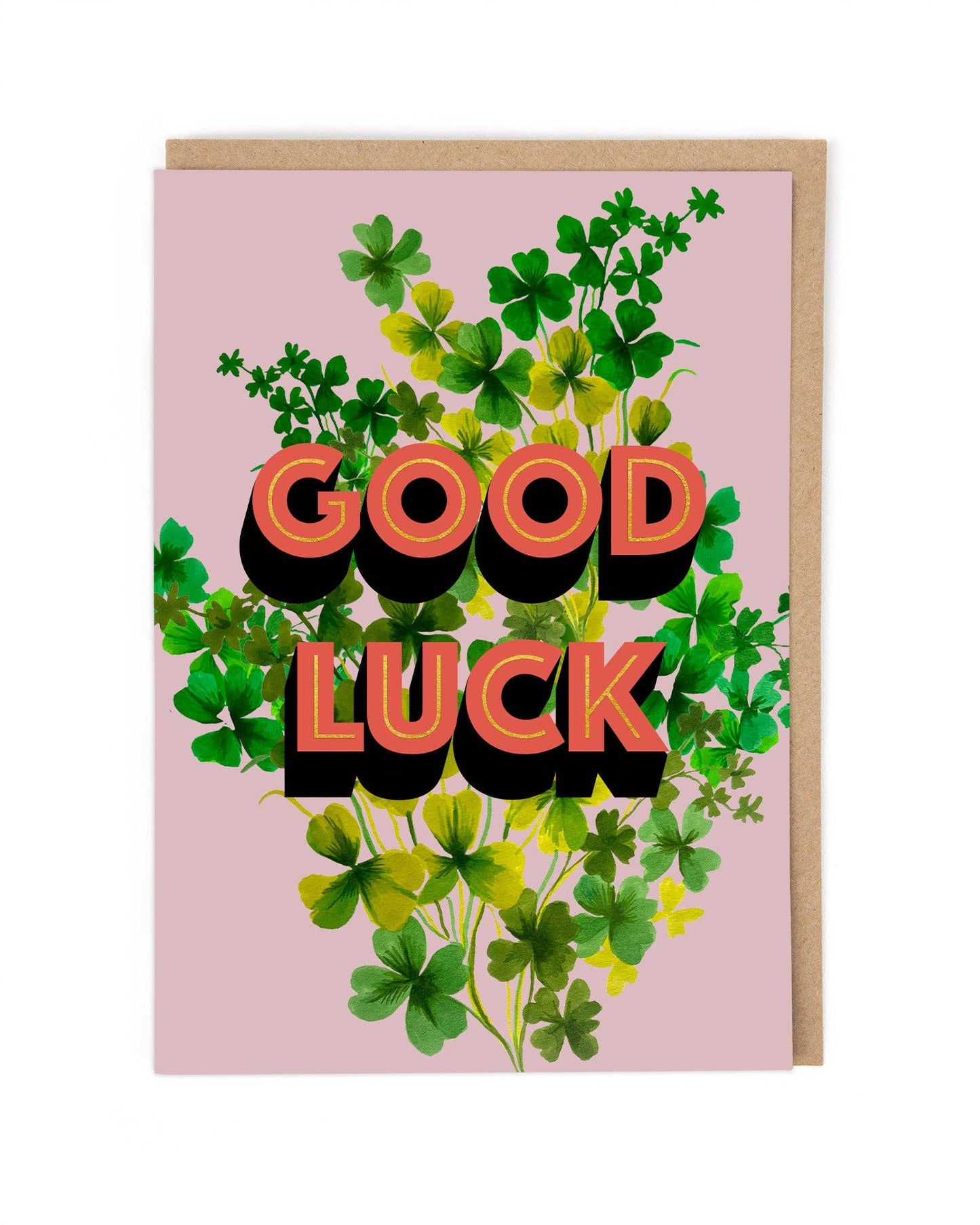 Greeting card with 'Good Luck' text surrounded by shamrocks on a pink background