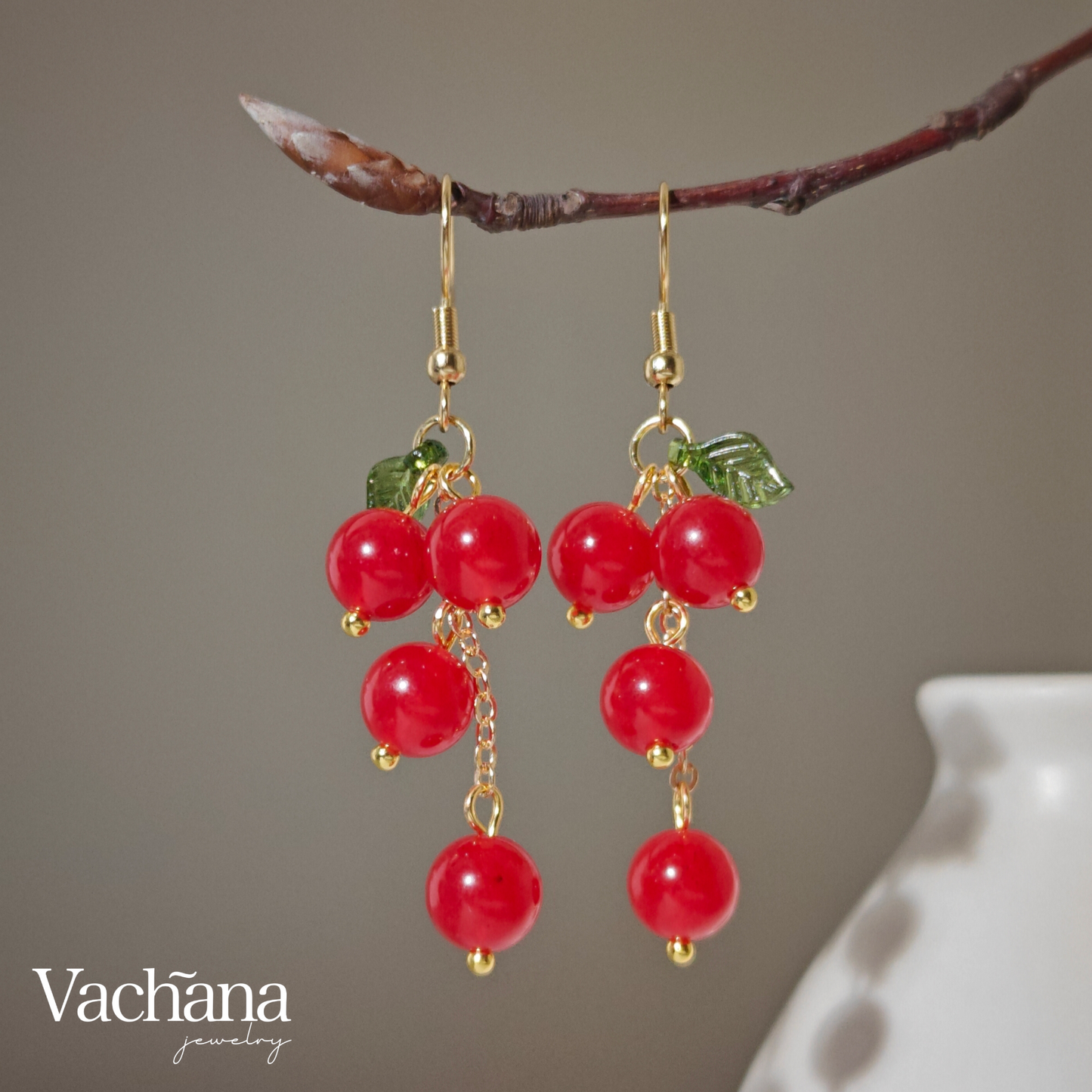 Cascade of red cherry gem stones with acrylic leaf on gold plated hooks