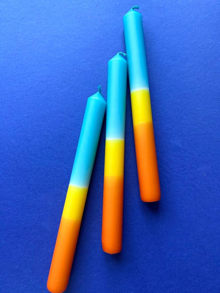 Trio of dip dyed candles. A band of orange, yellow and topped with turquoise.