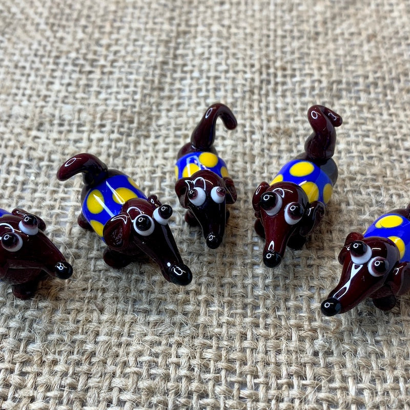 Friend in a box tiny glass brown dog with a spotty coat blue with yellow spots