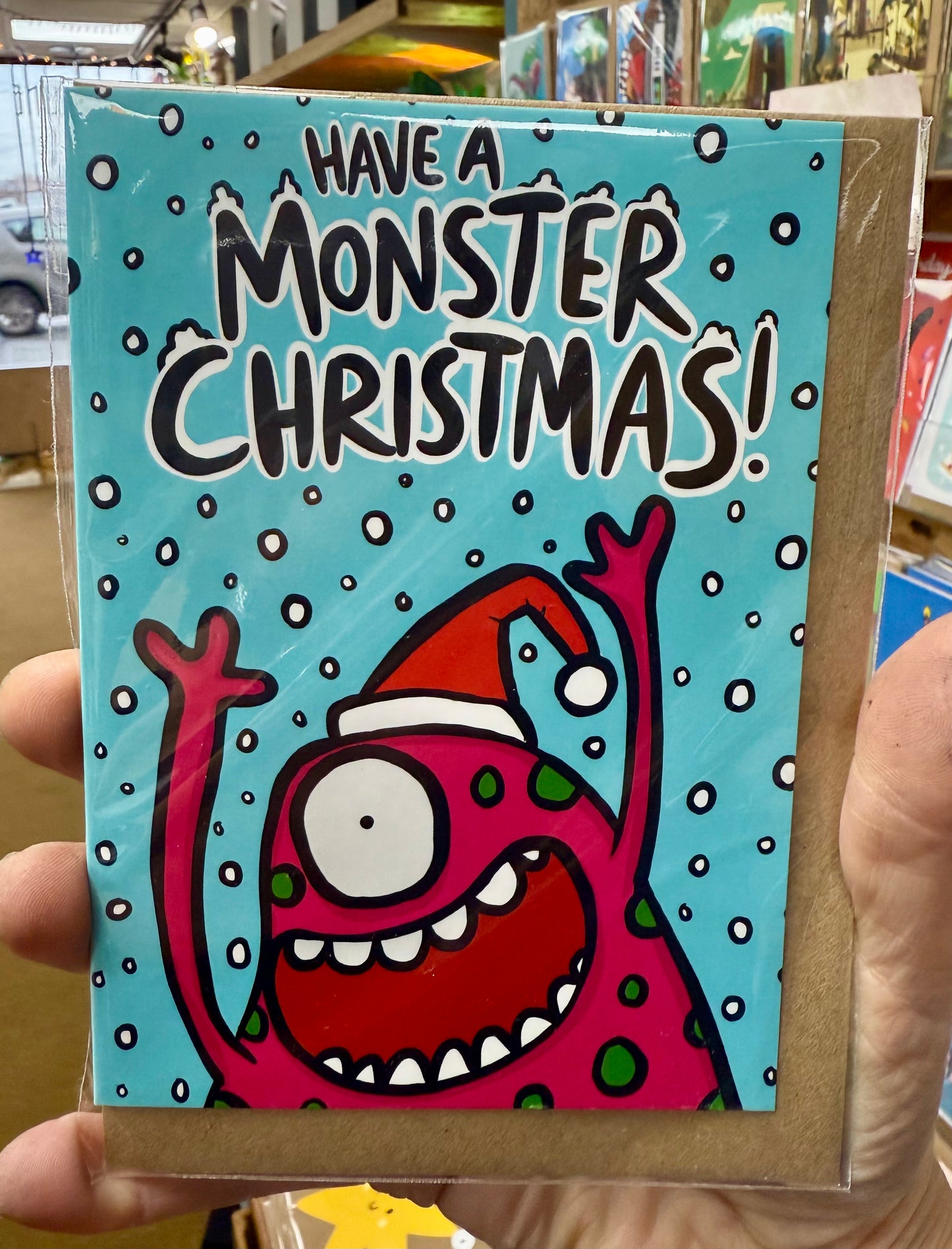 A googly eyed monster. Text reads Have a Monster Christmas