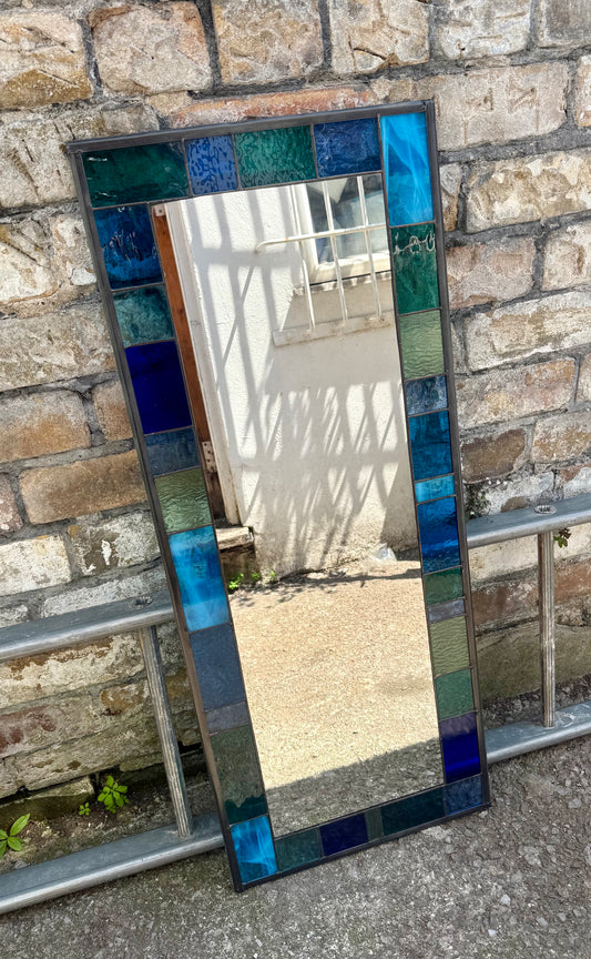 Full length stained glass mirror with a 6cm geometric border of blues, greens and aqua colours.