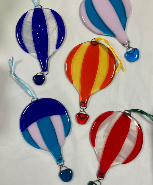 Random colours in various designs fused glass hot air balloons. A decorative glass hanging.