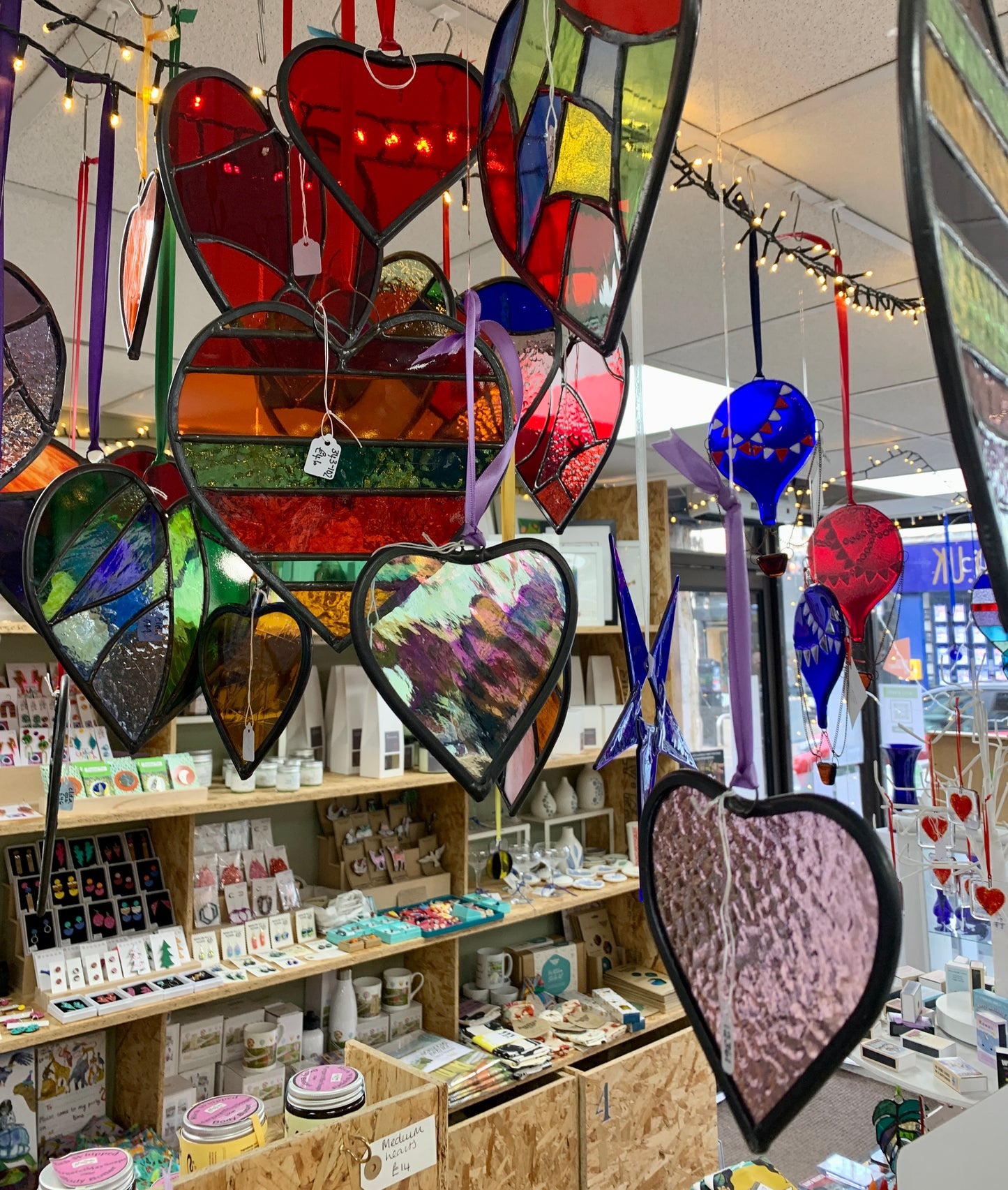 A medium sized Glass heart with a lead edging and a copper wire hook to hang in a window or outside in a tree