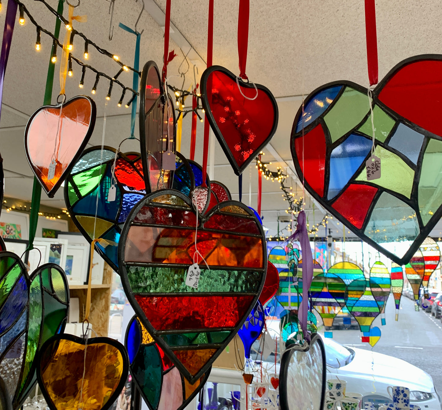 A medium sized Glass heart with a lead edging and a copper wire hook to hang in a window or outside in a tree