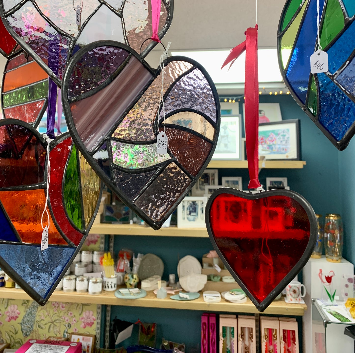 A medium sized Glass heart with a lead edging and a copper wire hook to hang in a window or outside in a tree