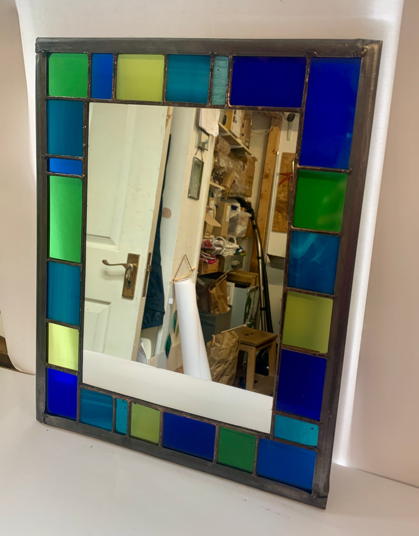 Stained Glass Mirror with randomly placed blue and green glass border.