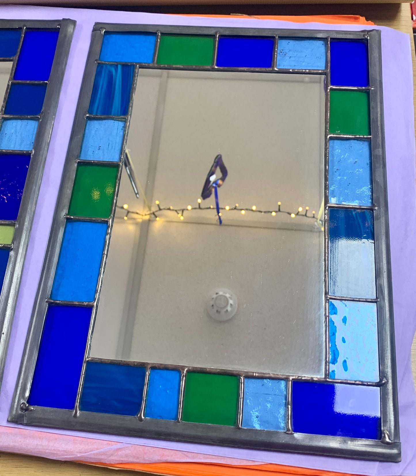 Stained Glass Mirror with randomly placed blue and green glass border.Stained Glass Mirror with randomly placed blue and green glass border. Stained Glass. Traditional Colour Glass. Blues, Aqua and Turquoise Glass.