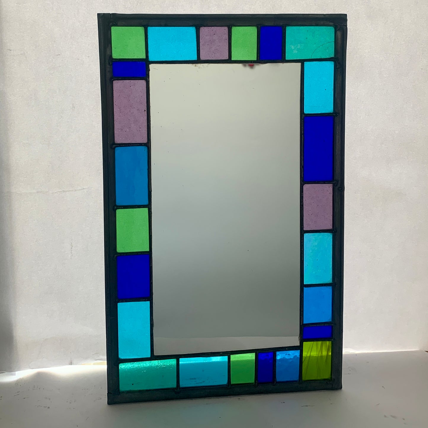 Stained Glass Mirror with randomly placed blue and green glass border. Stained Glass. Traditional Colour Glass. Blues, Aqua and Turquoise Glass.
