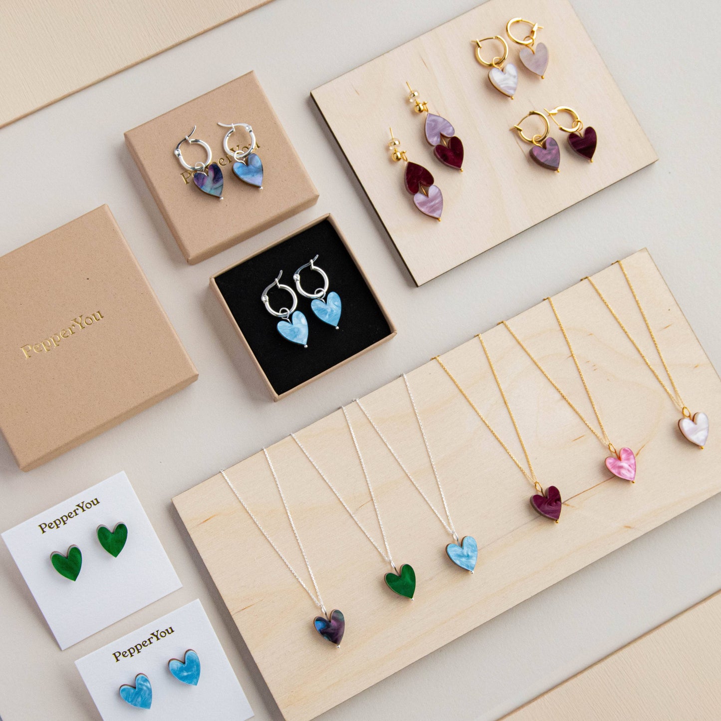 Jewelry set including earrings and necklaces on display with 'PepperYou' branding.