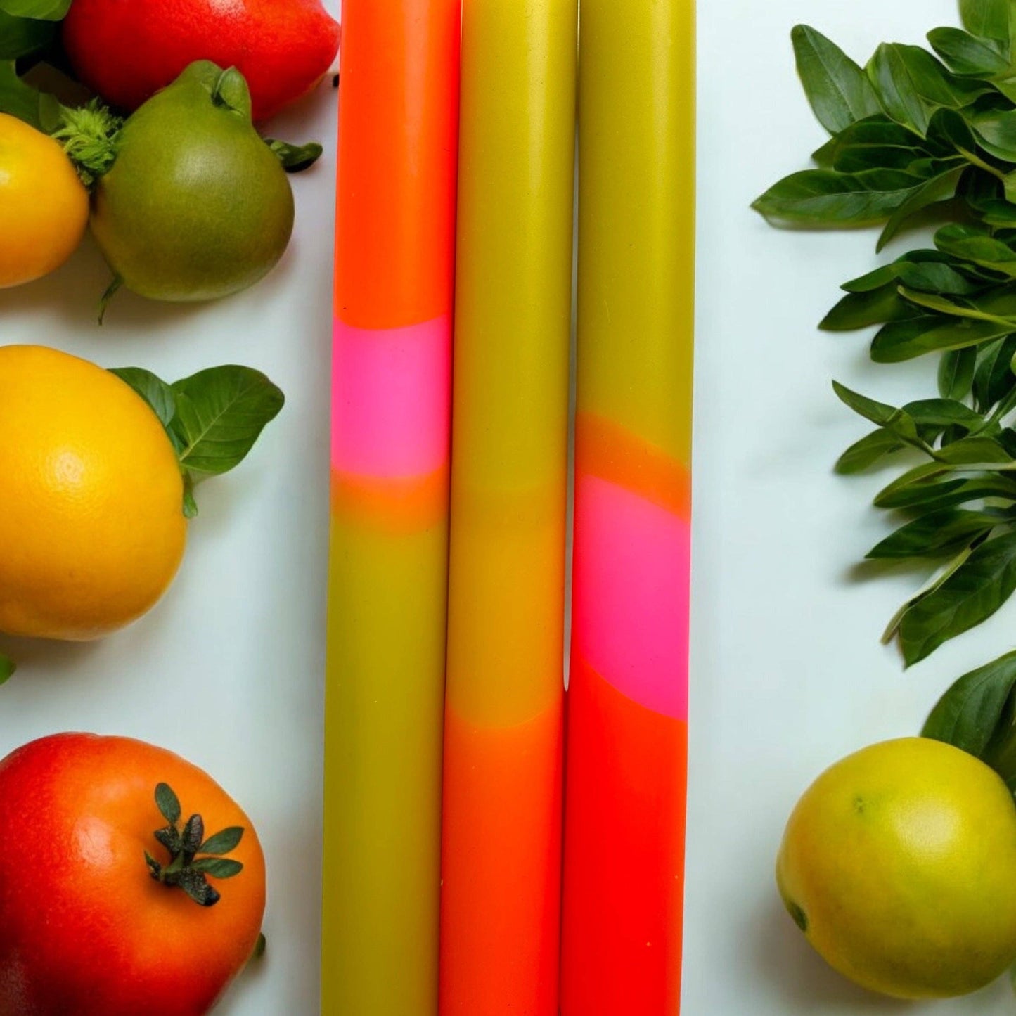 Trio of dinner candles. 70s inspired colours, olive green, orange and pink.