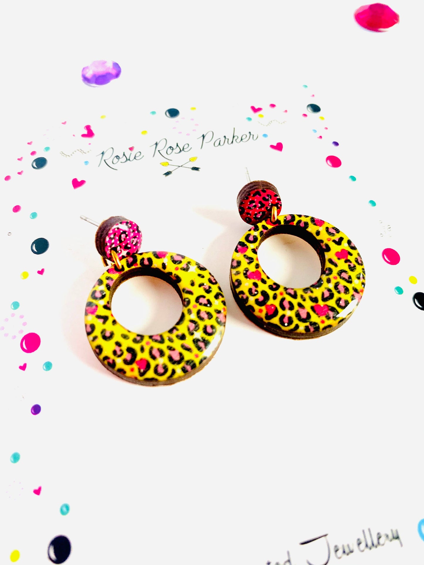 Pink and yellow leopard print earrings made from resin and wood.