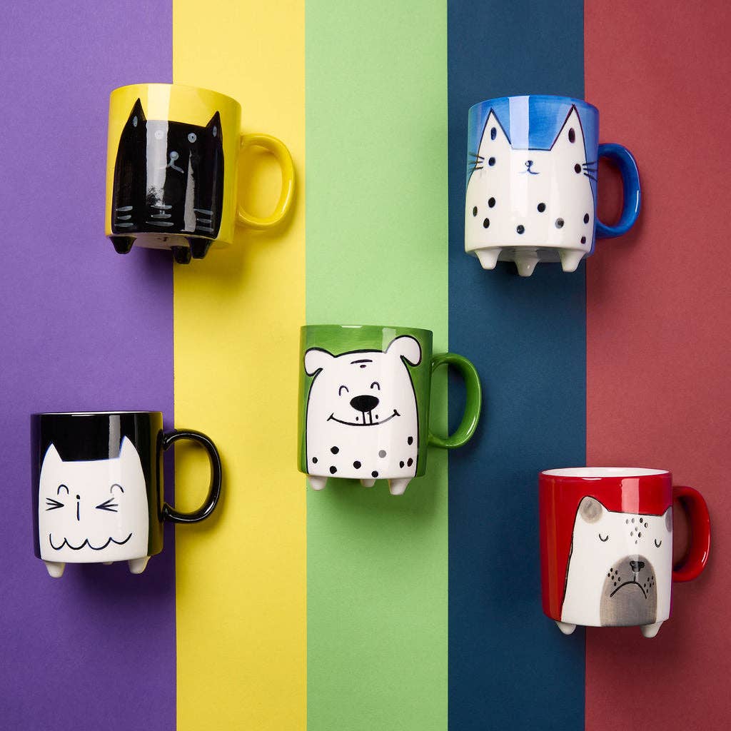 Set of colorful mugs with animal designs on a multicolored background