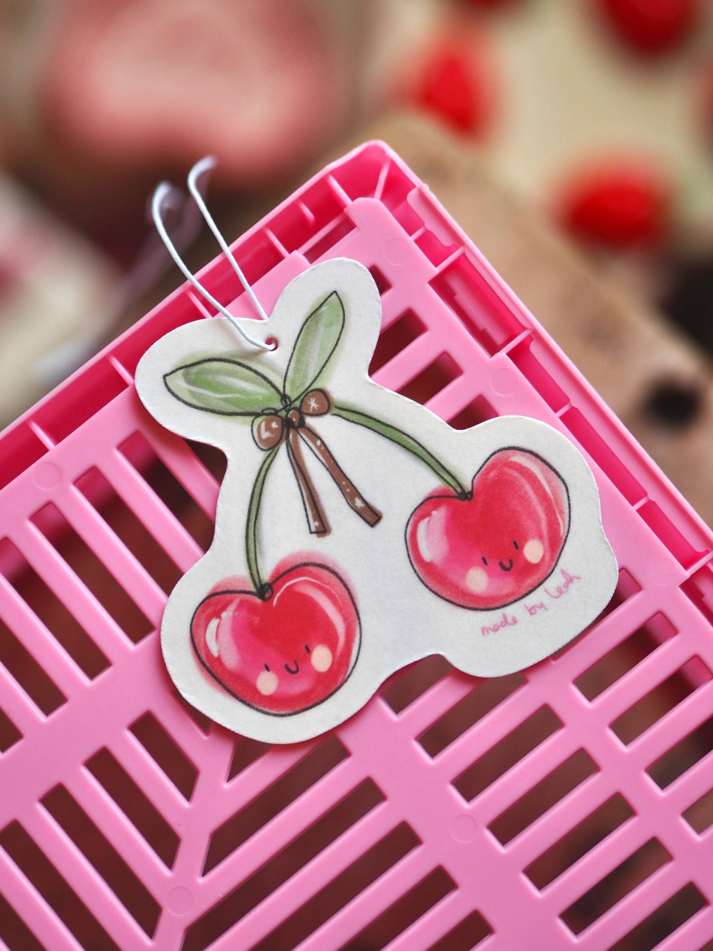 Cartoon cherry design on a pink background