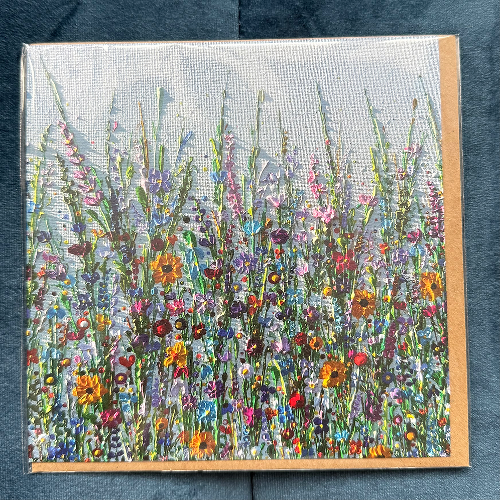 A square card depicting a colourful wildflower meadow against a grey background.