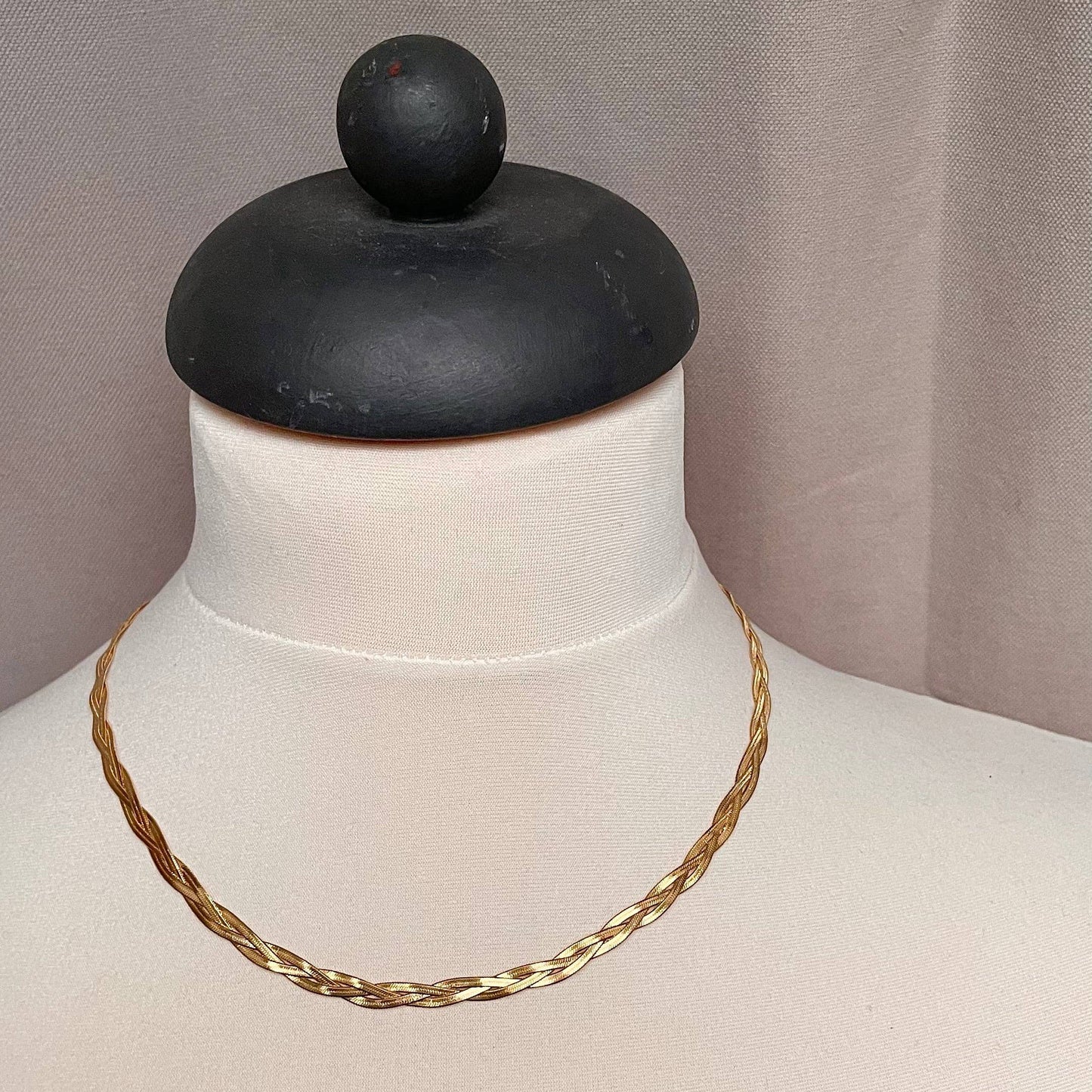 A gold plated plaited necklace.