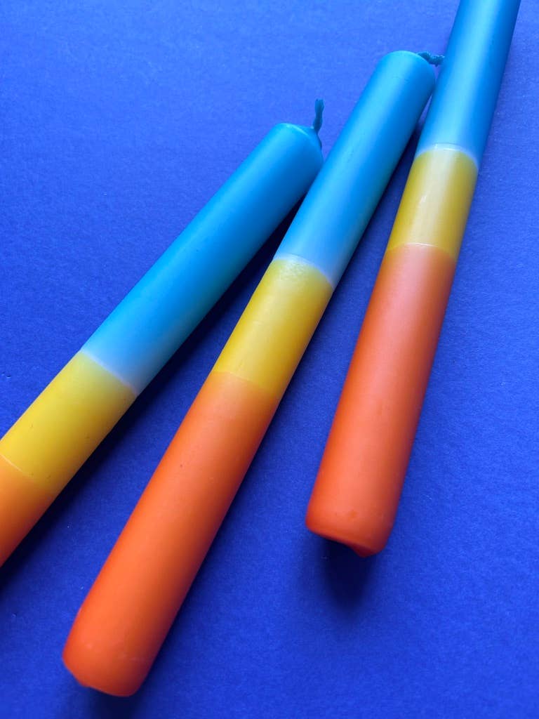 Trio of dip dyed candles. A band of orange, yellow and topped with turquoise.