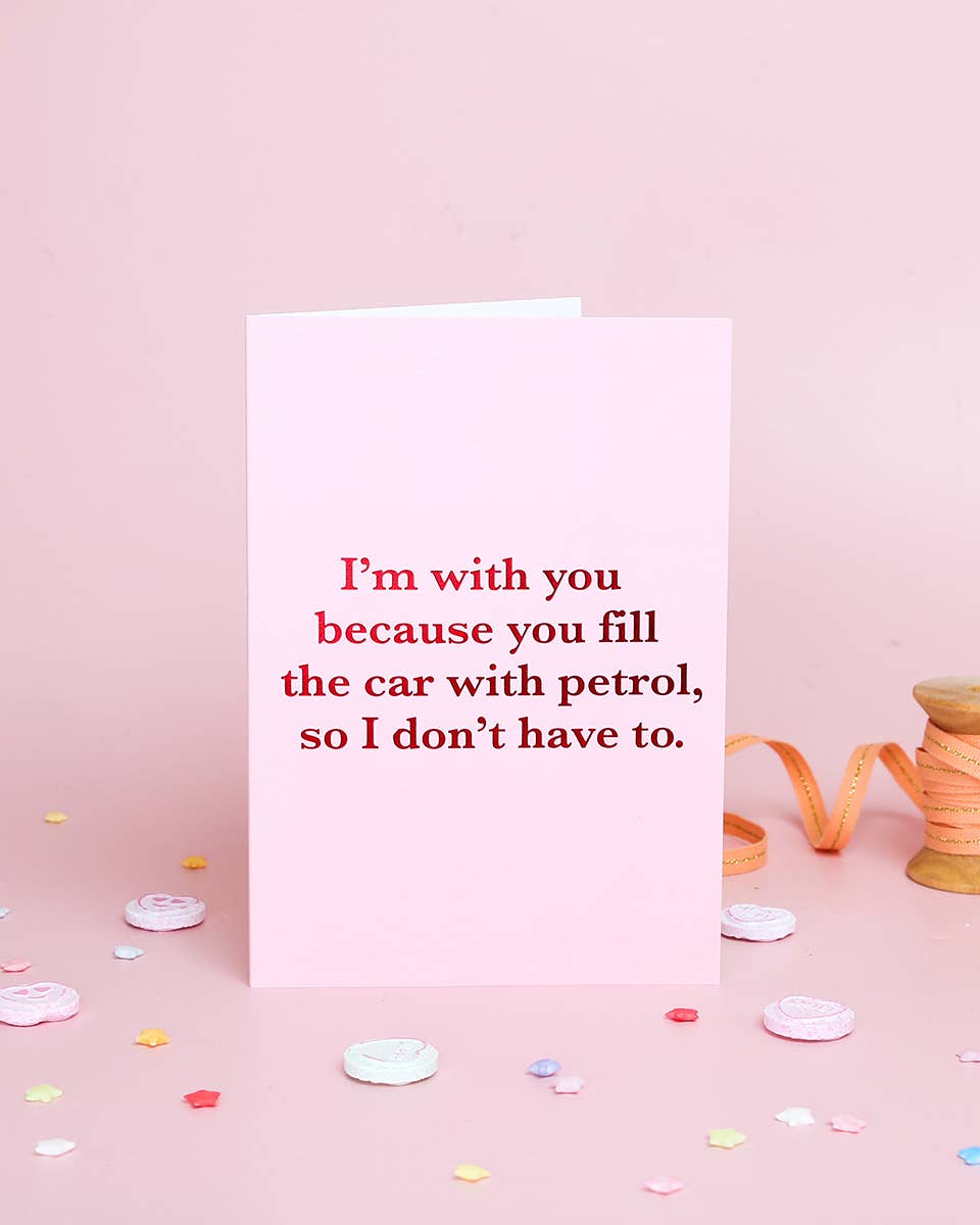 Card with humorous text on a pink background with ribbons and confetti.