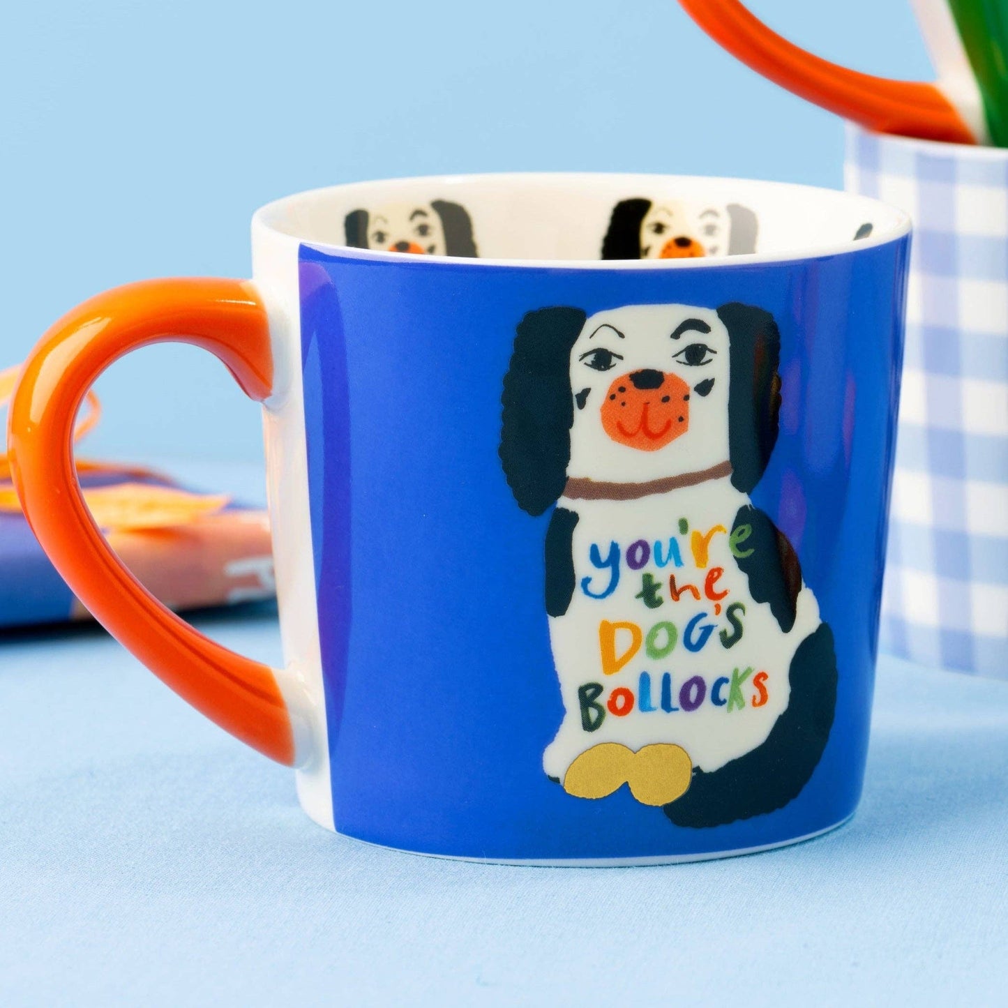Blue mug with a dog illustration and text on a blue background